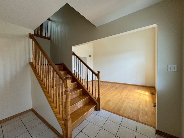 stairs with light tile floors