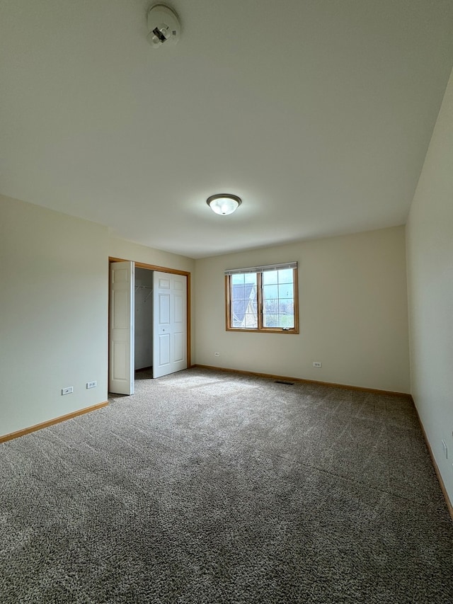 unfurnished bedroom with a closet and carpet floors