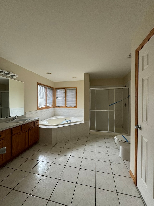 full bathroom with tile floors, oversized vanity, independent shower and bath, and toilet