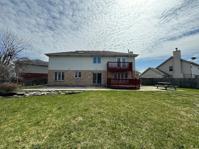 back of house featuring a yard, a balcony, and a patio