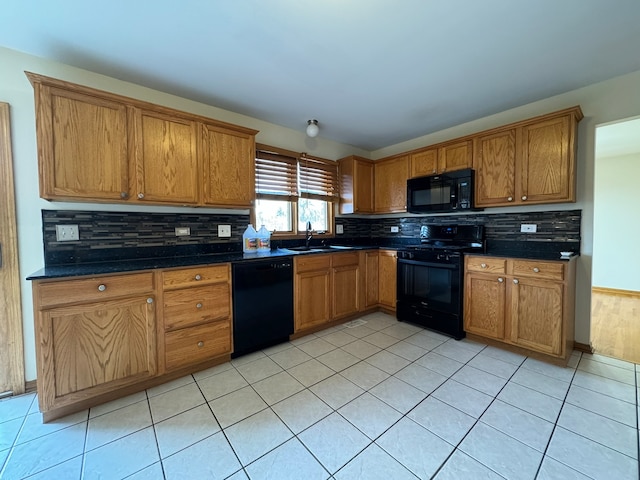 kitchen featuring backsplash, sink, light tile flooring, and black appliances