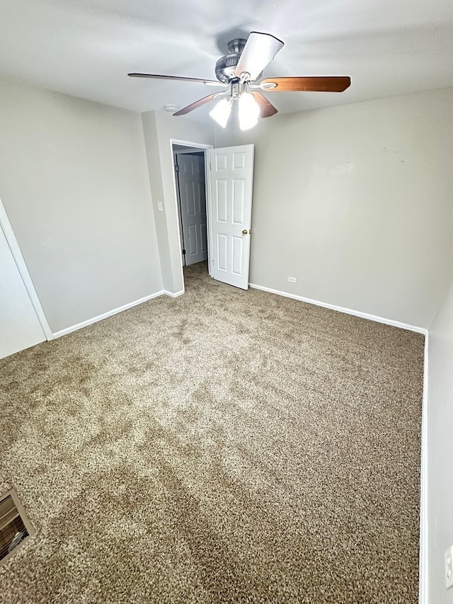 spare room featuring carpet flooring and ceiling fan