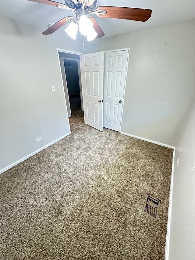 unfurnished bedroom featuring ceiling fan and carpet floors