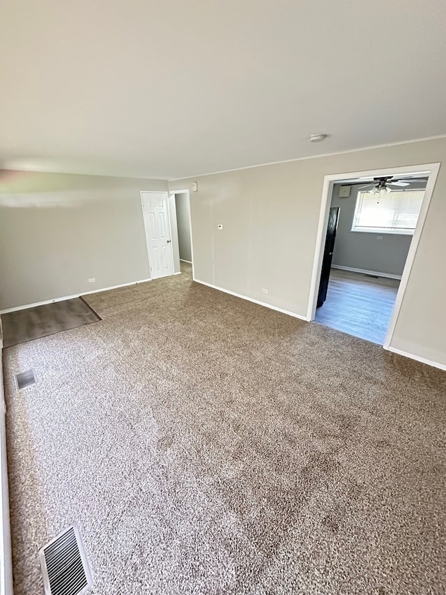 carpeted empty room with ceiling fan