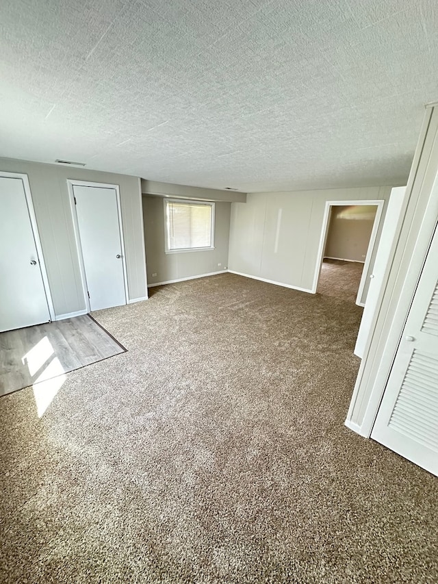 unfurnished bedroom featuring a closet, a textured ceiling, and carpet