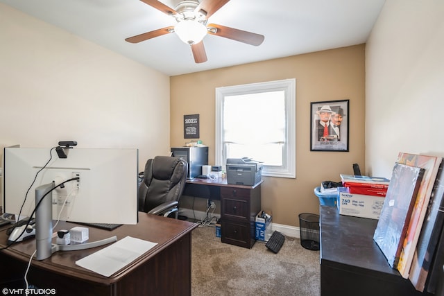 carpeted home office featuring ceiling fan