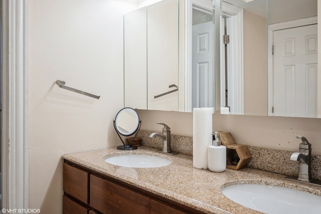 bathroom featuring dual vanity