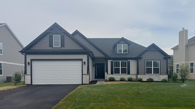 craftsman inspired home featuring driveway, stone siding, and a front yard