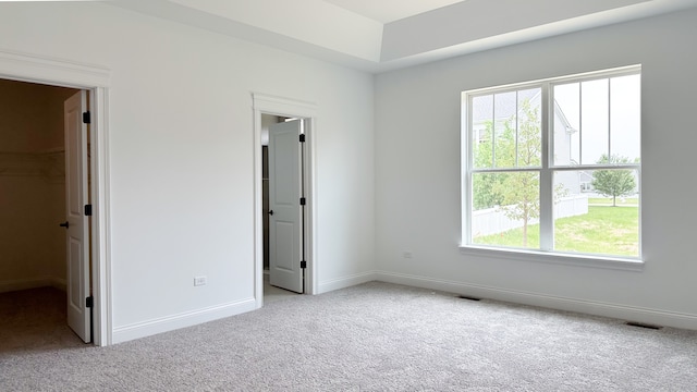 unfurnished bedroom featuring light colored carpet, visible vents, and baseboards