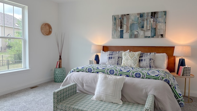 carpeted bedroom with baseboards and visible vents