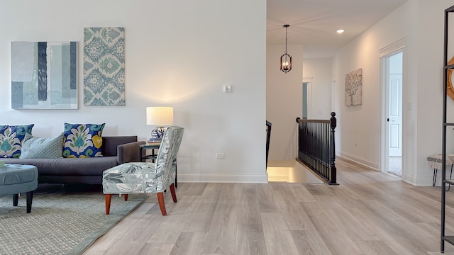 living area featuring recessed lighting, light wood-type flooring, and baseboards