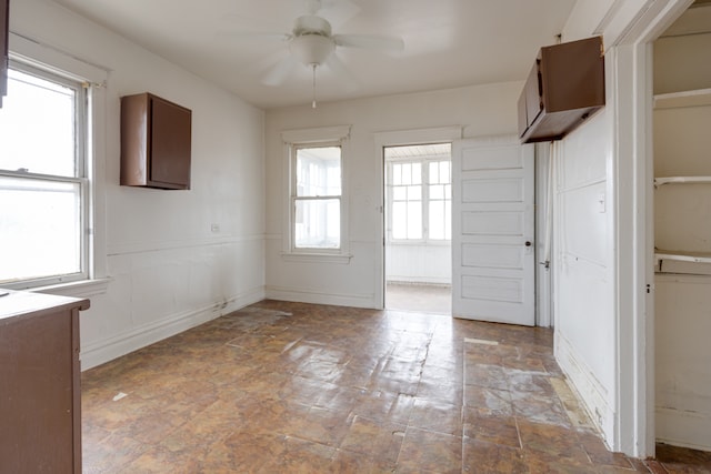 tiled empty room with ceiling fan