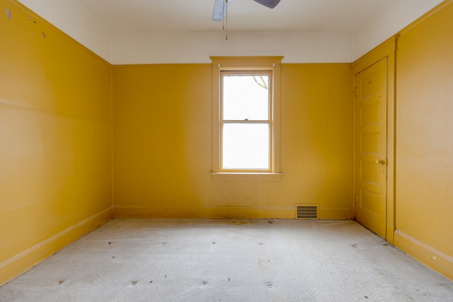 spare room featuring plenty of natural light, ceiling fan, and carpet floors