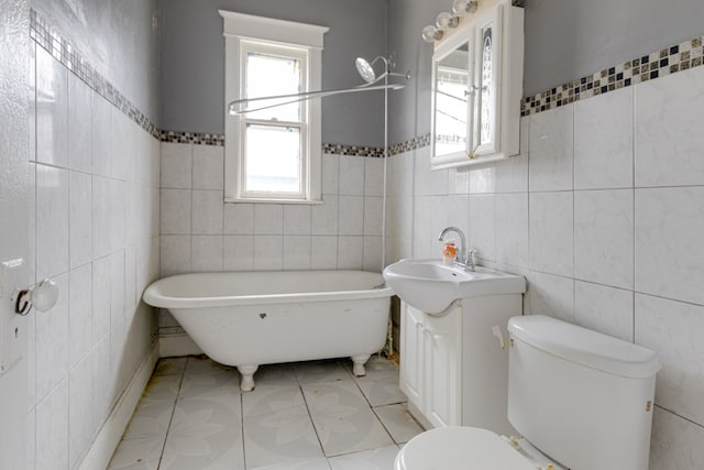 bathroom featuring a wealth of natural light, toilet, tile flooring, and tile walls