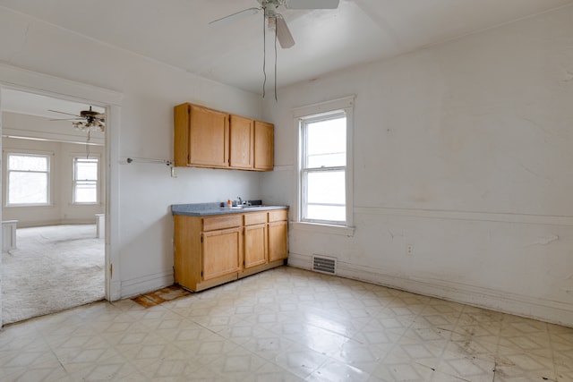 kitchen featuring ceiling fan, light tile flooring, and plenty of natural light