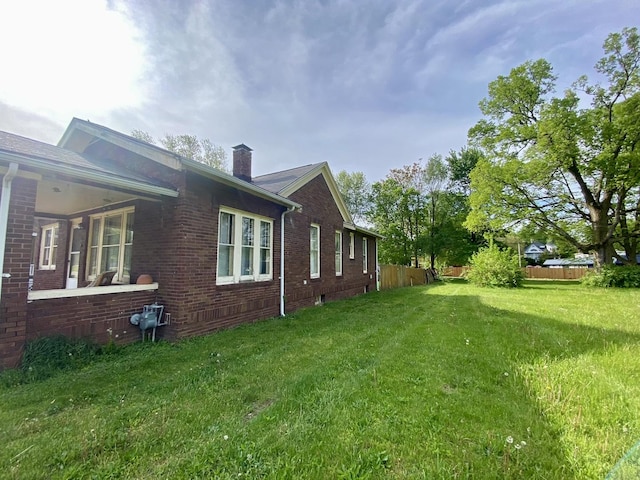 657 W Wood St, Decatur, IL 62522 - view of home's exterior with a chimney and brick siding
