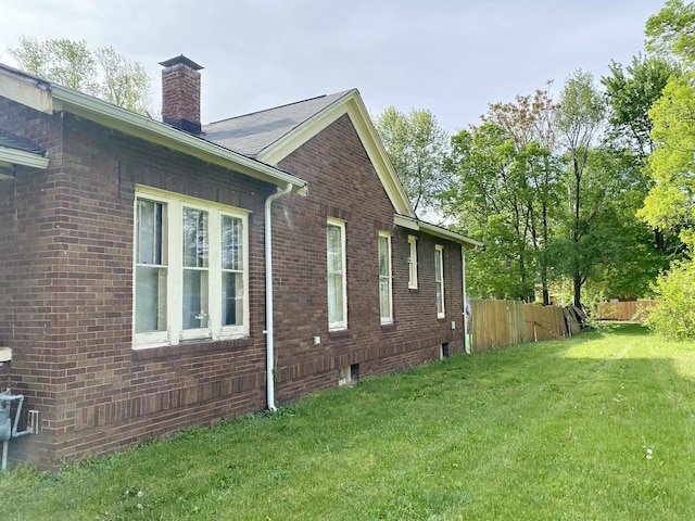 657 W Wood St, Decatur, IL 62522 - view of side of home with a chimney and brick siding