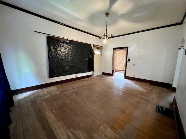 657 W Wood St, Decatur, IL 62522 - spare room with wood finished floors, a chandelier, ornamental molding, and baseboards