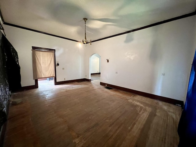 657 W Wood St, Decatur, IL 62522 - unfurnished room with arched walkways, crown molding, wood finished floors, and baseboards