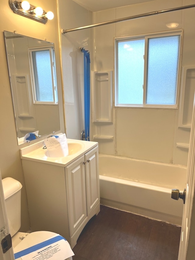 full bathroom featuring shower / washtub combination, a healthy amount of sunlight, vanity, and hardwood / wood-style flooring