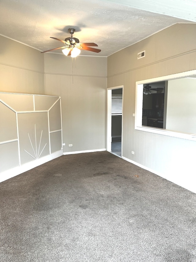 spare room featuring carpet flooring, ceiling fan, and a textured ceiling