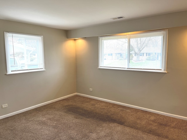 carpeted empty room featuring a healthy amount of sunlight