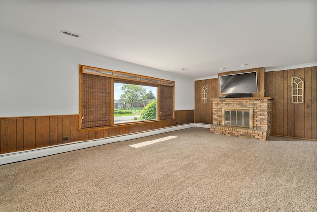 6840 157th St, Tinley Park, IL 60477 - unfurnished living room with wooden walls, carpet flooring, a fireplace, and a wainscoted wall