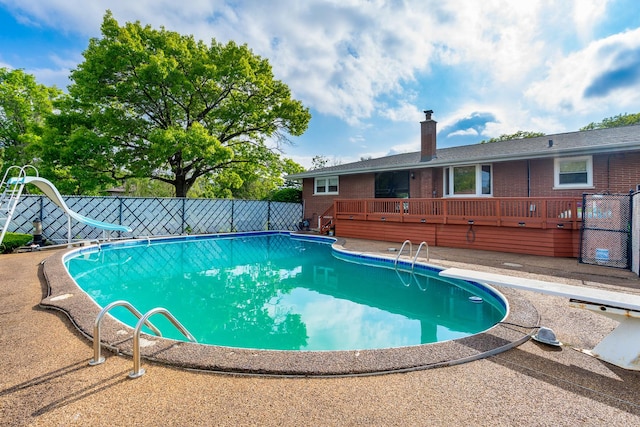 6840 157th St, Tinley Park, IL 60477 - view of swimming pool featuring a diving board, a water slide, and a wooden deck
