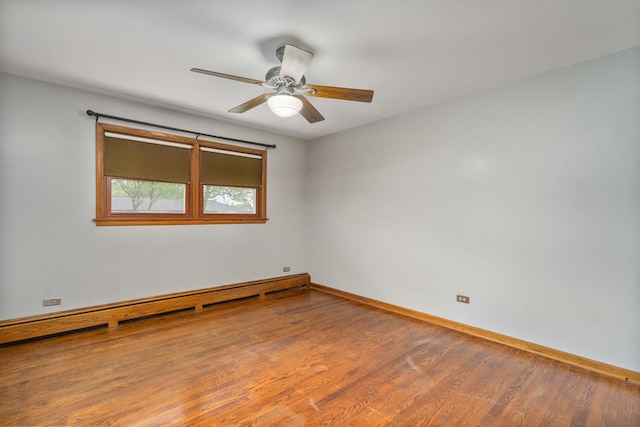6840 157th St, Tinley Park, IL 60477 - empty room with wood finished floors, baseboard heating, a ceiling fan, and baseboards
