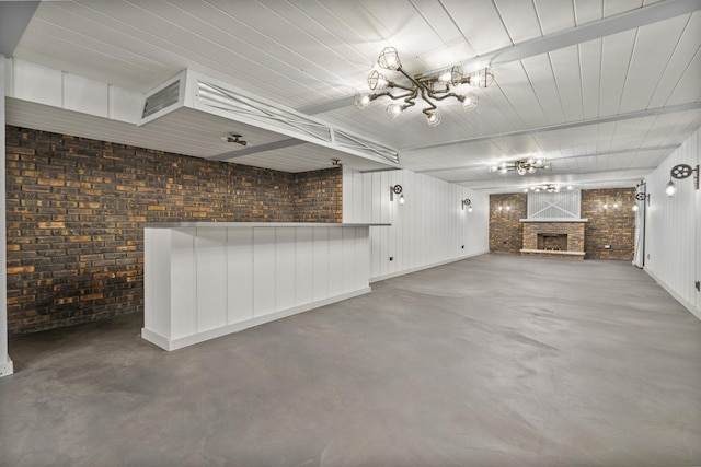 6840 157th St, Tinley Park, IL 60477 - unfurnished living room featuring finished concrete floors, a chandelier, a fireplace with raised hearth, and brick wall