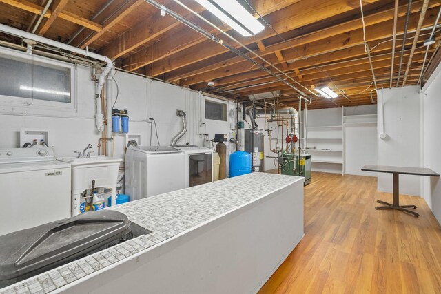 6840 157th St, Tinley Park, IL 60477 - unfinished basement featuring a heating unit, washer and dryer, light wood-type flooring, a water pressure tank, and water heater