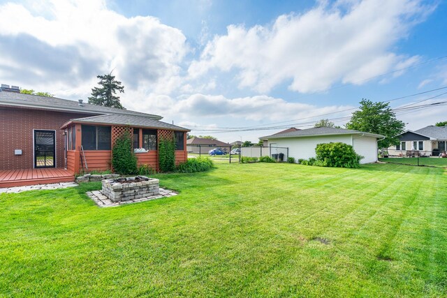 6840 157th St, Tinley Park, IL 60477 - view of yard featuring an outdoor fire pit, a deck, and a sunroom