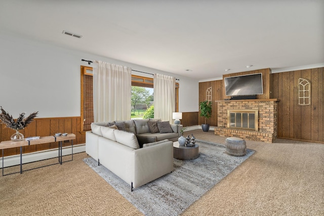 6840 157th St, Tinley Park, IL 60477 - carpeted living room with wood walls, a fireplace, a baseboard heating unit, wainscoting, and a baseboard radiator