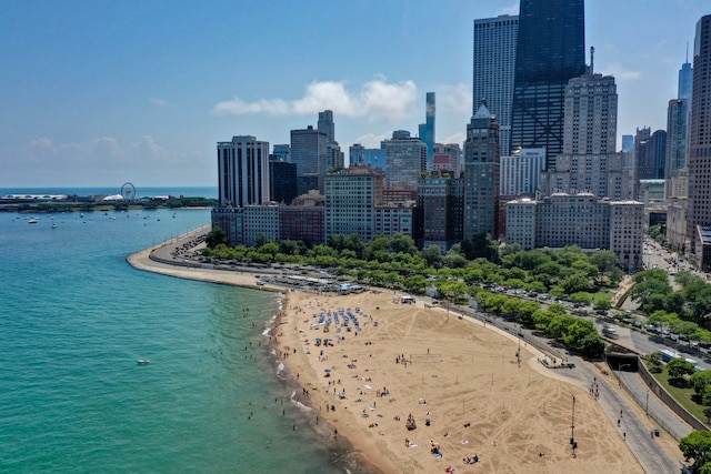 property's view of city with a water view and a beach view