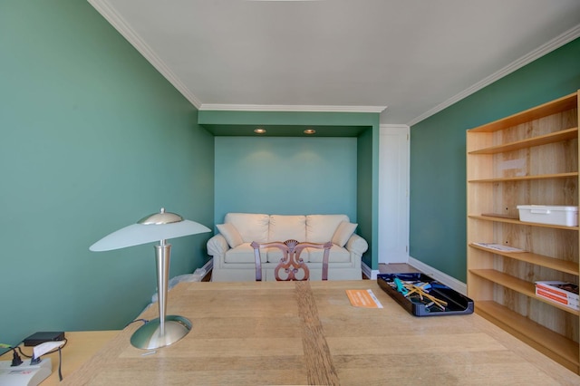 sitting room featuring ornamental molding and baseboards