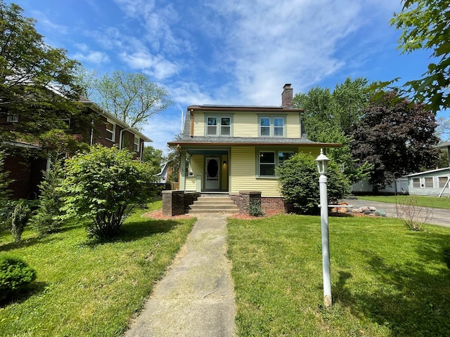 view of front facade with a front lawn and covered porch