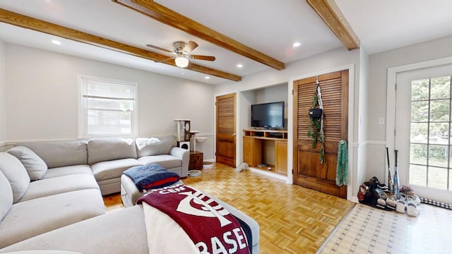 living room with beamed ceiling, ceiling fan, and parquet floors