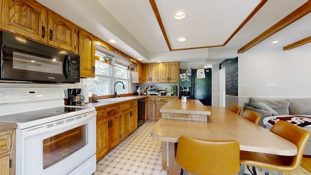 kitchen with light tile floors, a kitchen island, sink, a breakfast bar area, and black appliances