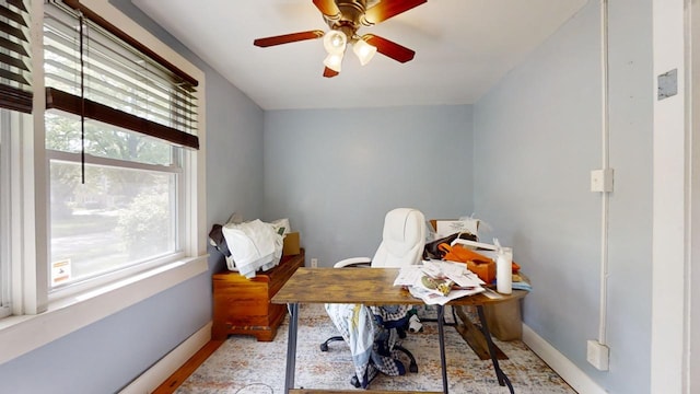 office area with plenty of natural light and ceiling fan