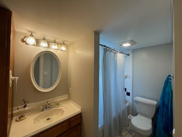 full bathroom with shower / tub combo, vanity, and toilet