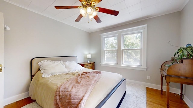 bedroom with hardwood / wood-style floors and ceiling fan