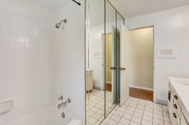 bathroom featuring tiled shower / bath combo, vanity, and wood-type flooring