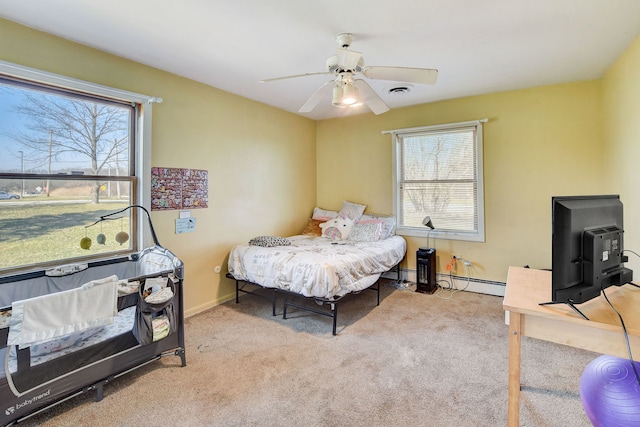 carpeted bedroom featuring ceiling fan and a baseboard radiator