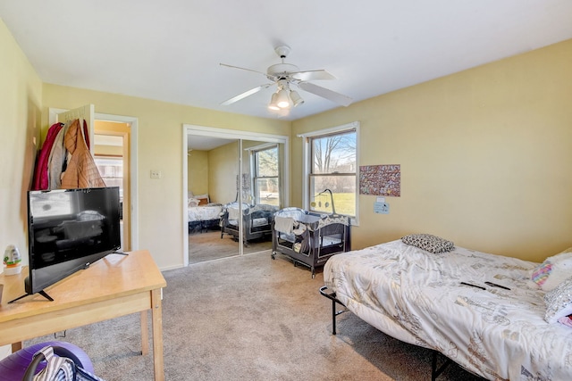 bedroom featuring ceiling fan, a closet, and light carpet