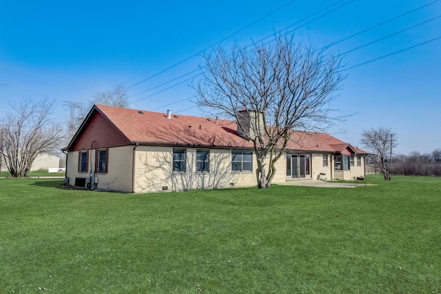 rear view of property featuring a lawn