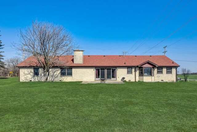 back of house with a lawn