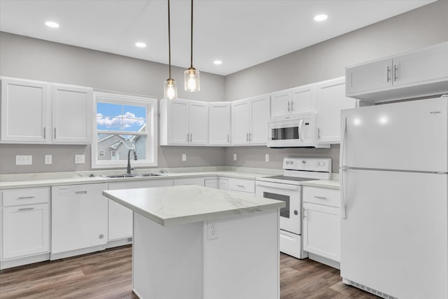 kitchen with white cabinetry, sink, dark wood-type flooring, white appliances, and a kitchen island