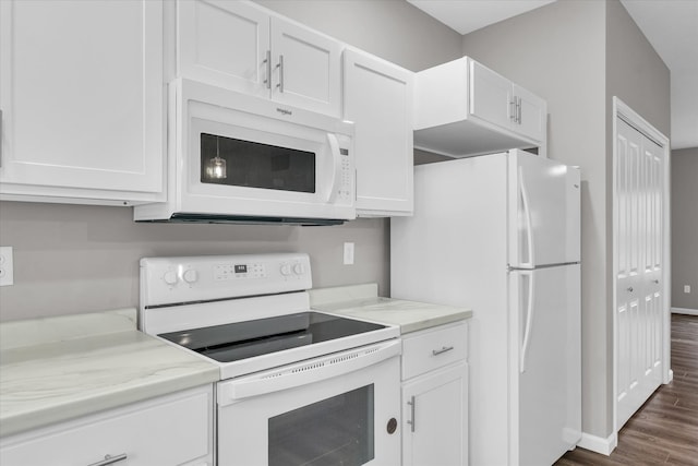 kitchen featuring dark hardwood / wood-style flooring, white appliances, and white cabinetry