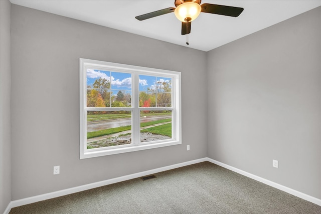 carpeted empty room featuring ceiling fan