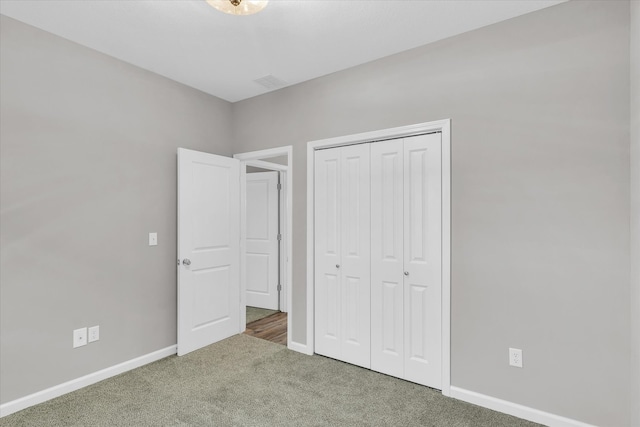 unfurnished bedroom with carpet and a closet